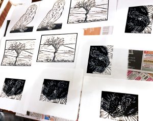 A picture of some of the prints I've made including a tree, an owl, and our black cat Bluebell